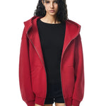 Model in vibrant red high-neck zip hoodie, adding a bold pop of color to the edgy silhouette.