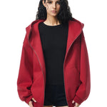 Side view of red oversized hoodie on model, showcasing dropped shoulders and loose fit back.