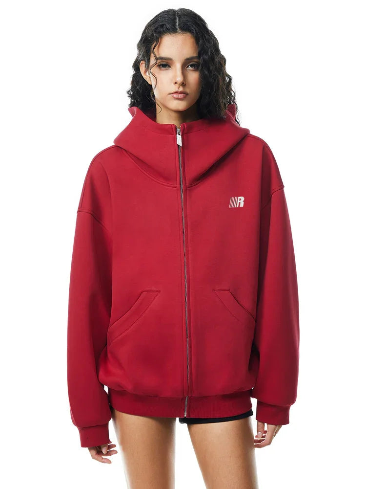 Side view of red oversized hoodie on model, showcasing dropped shoulders and loose fit back.